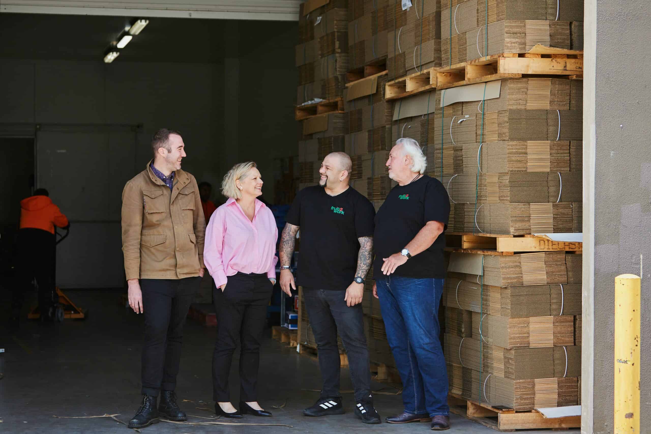 Tyron Bravo, Corinne Proske, Simon Fenech and Rob Brown in the loading bay at Fruit2Work